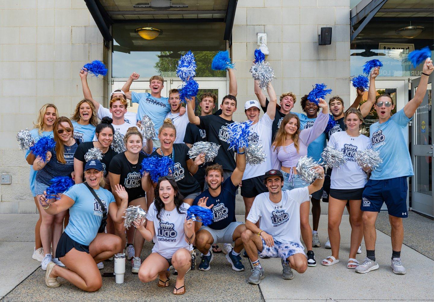 ODU swim team with pom poms outside Chartway Arena