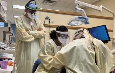 dental hygiene students work on a patient 