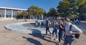 Students walking by Monarch fountain